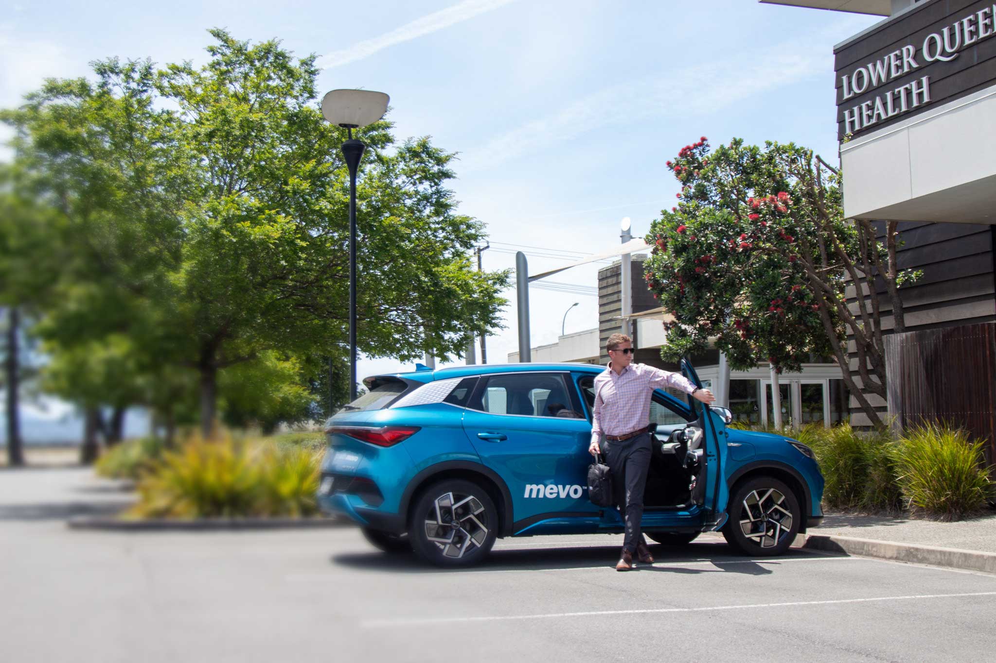 Mevo vehicle with business man exiting the driver door