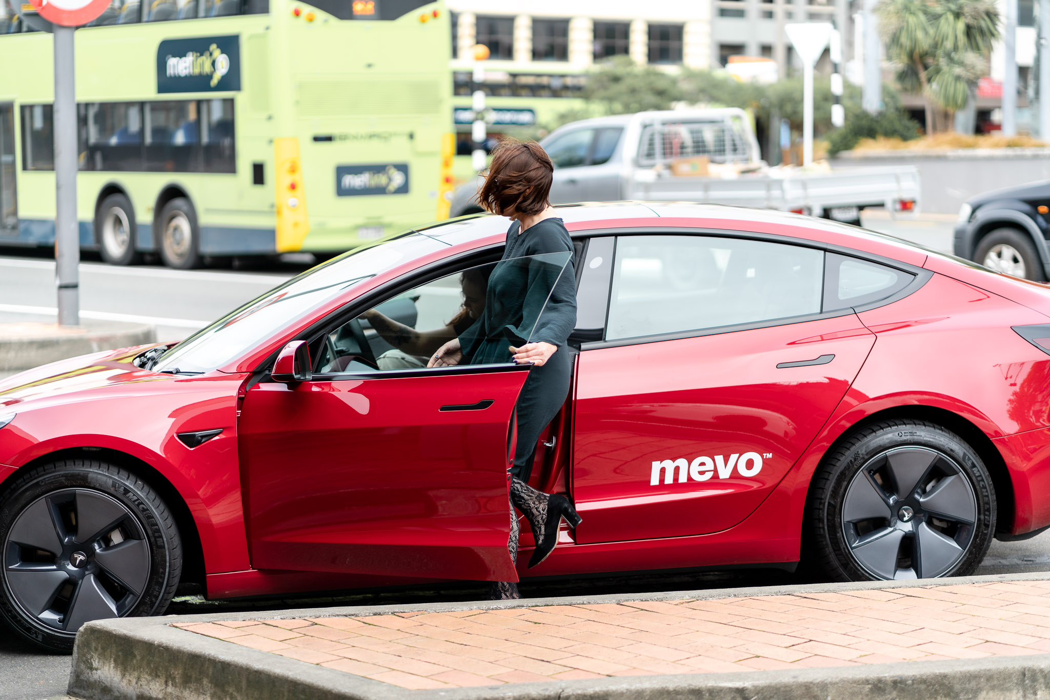 Two of the Copo Property Management team getting into a Mevo vehicle on Courtenay Place, Wellington.
