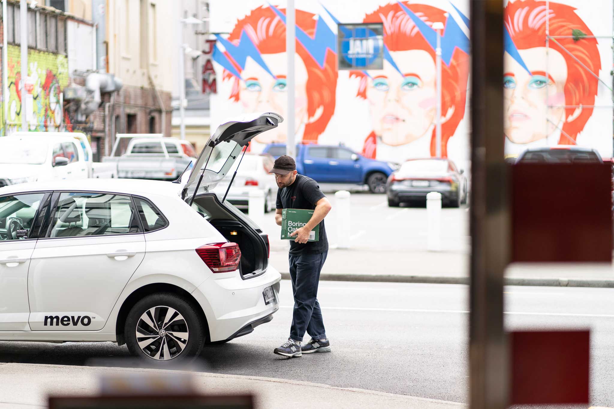 Tim loading boxes into the back of a Mevo car.