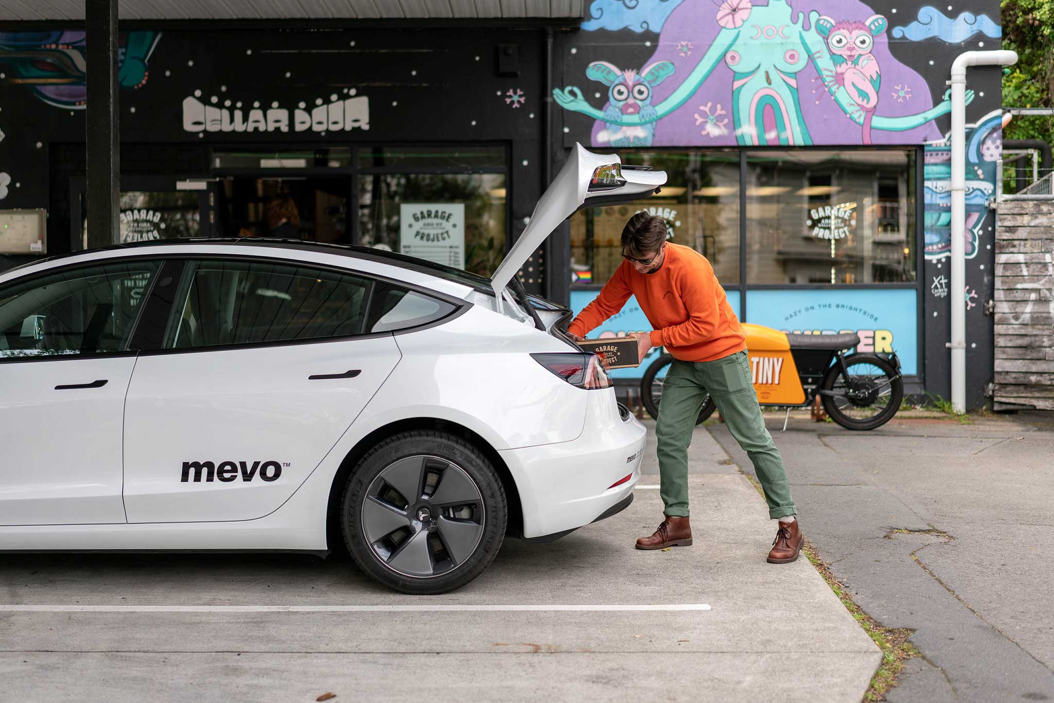 Crocky loading a case of Garage Project beer into the back of a Mevo.