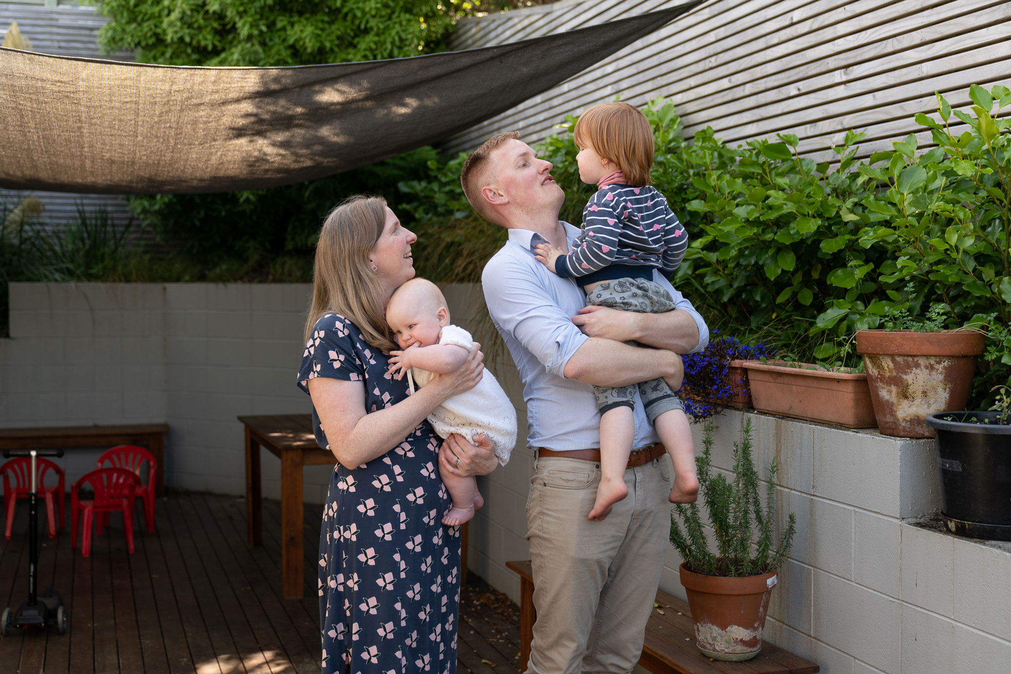 James, his wife, and their two children in their back garden.