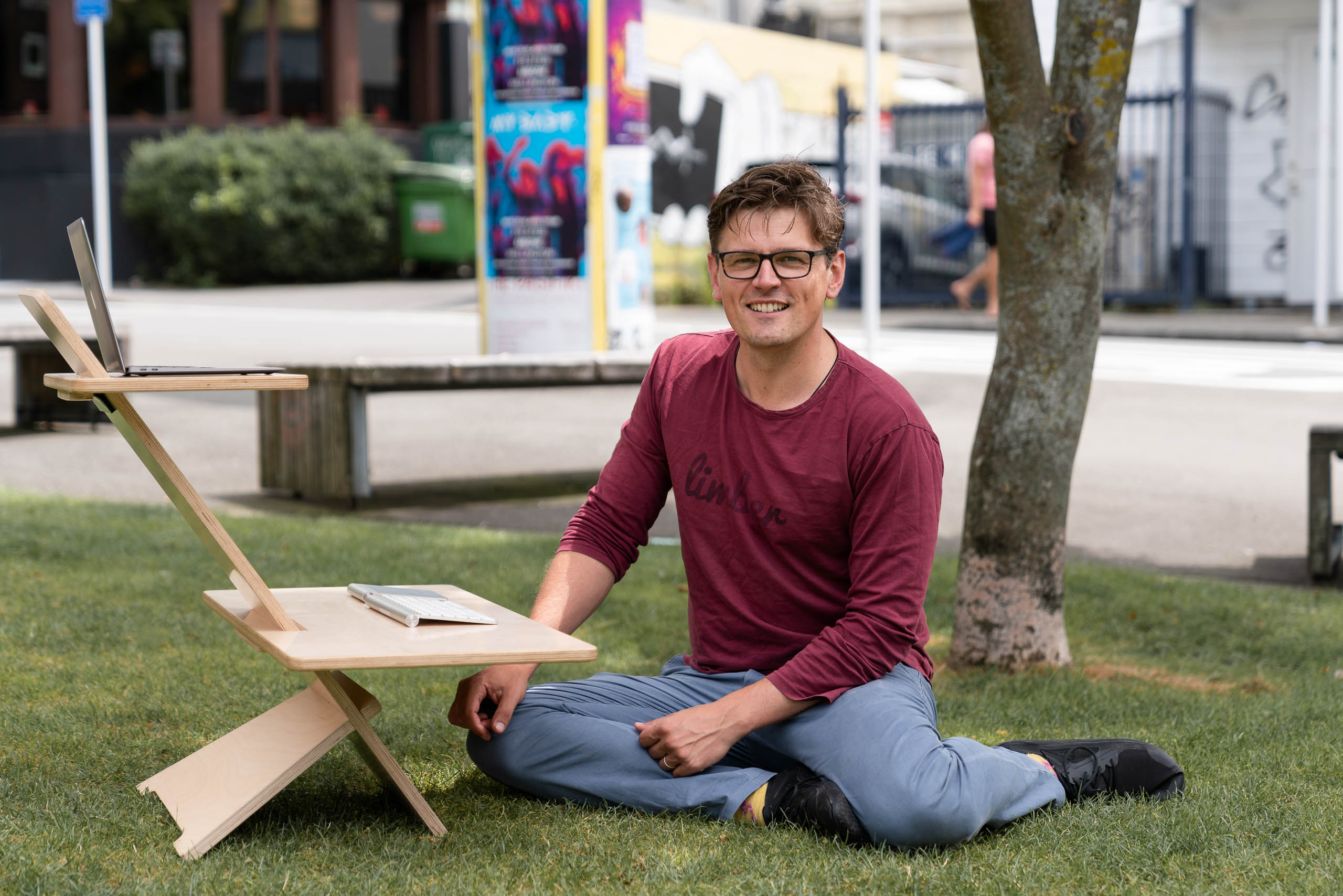 Limber founder Bart sitting at a Limber Mini desk in a park in central Wellington.