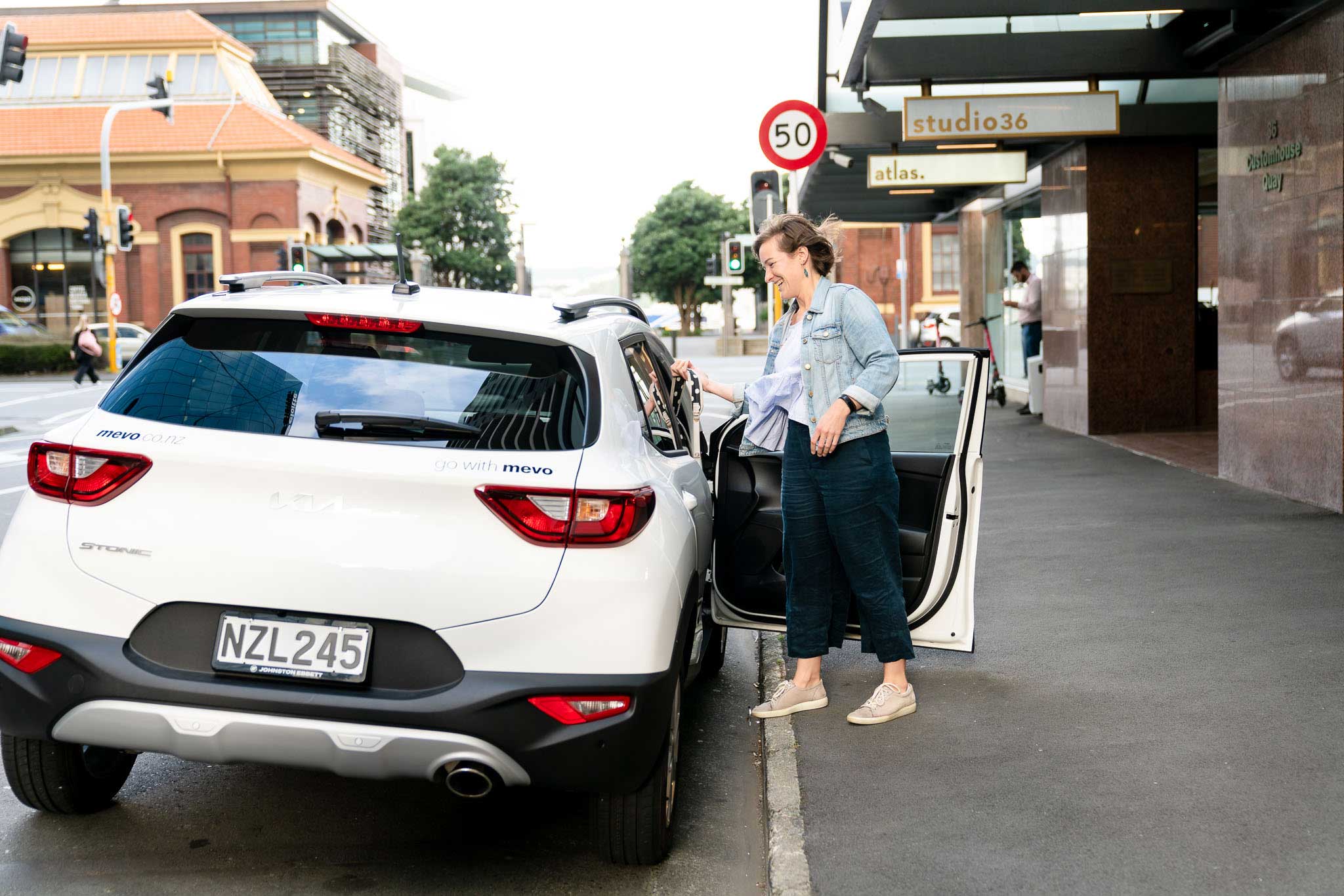 Ursula getting into of a Mevo car in Central Wellington.