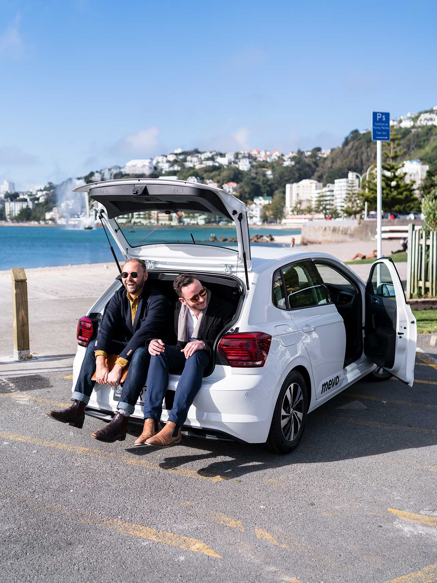 Erik and Finn sitting in the boot of a Mevo car.